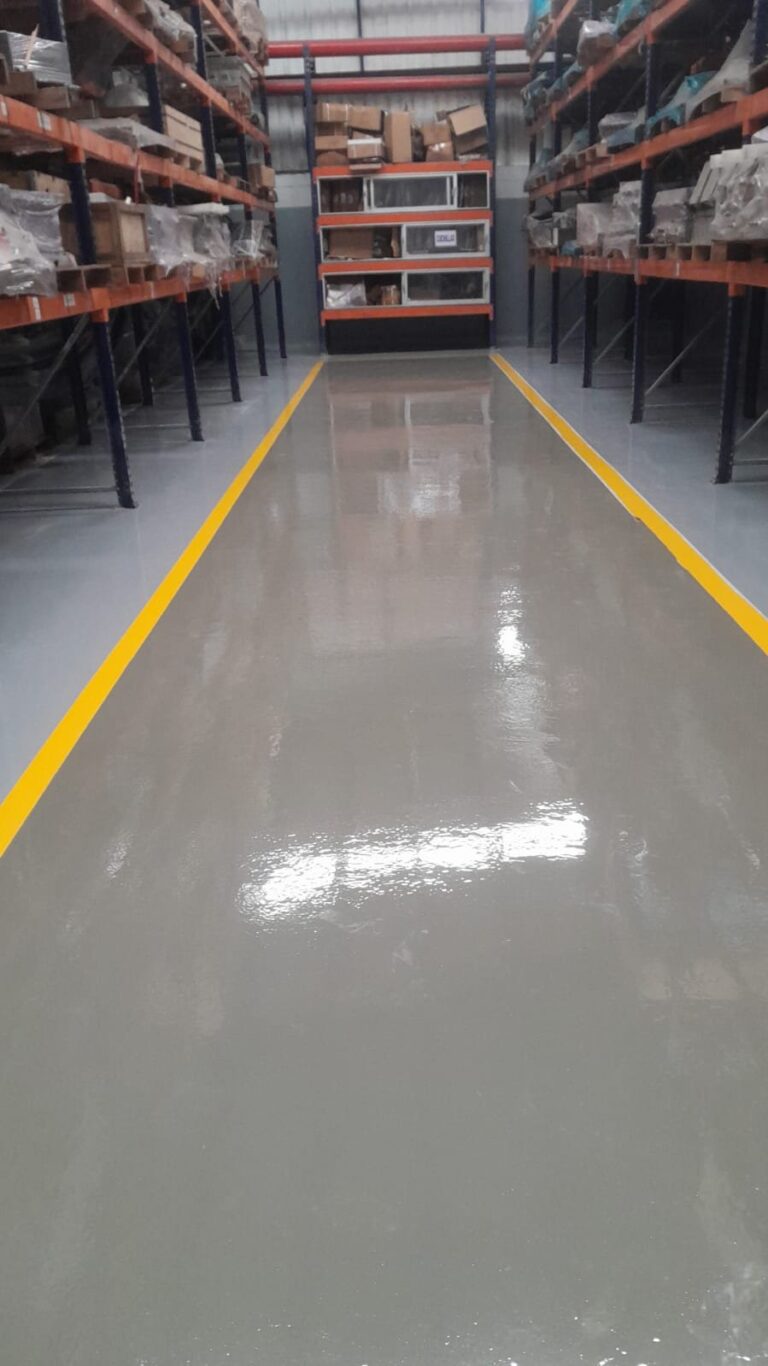 Pasillo demarcado con piso epóxico Danofloor ES PRO en fábrica de plásticos, obra de GSA Ingeniería